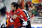 WASHINGTON - NOVEMBER 01:  Alex Ovechkin #8 of the Washington Capitals holds his shoulder as he is escorted to the penalty box after receiving a roughing penalty in the second period against the Columbus Blue Jackets at the Verizon Center on November 1, 2009 in Washington, DC.  (Photo by Greg Fiume/Getty Images)