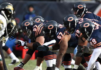 CHICAGO - DECEMBER 07: Orlin Kreutz #57 of the Chicago Bears prepares to snap the ball as teammates Josh Beekman #67, John St. Clair #78 and Desmond Clark #88 await the start of a play against the Jacksonville Jaguars on December 7, 2008 at Soldier Field in Chicago, Illinois. The Bears defeated the Jaguars 23-10. (Photo by Jonathan Daniel/Getty Images)