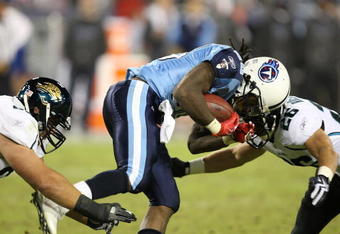 NASHVILLE, TN - NOVEMBER 01:  Chris Johnson #28 of the Tennessee Titans hits Brian Russell #26 of the Jacksonville Jaguars during their game at LP Field on November 1, 2009 in Nashville, Tennessee.  (Photo by Streeter Lecka/Getty Images)