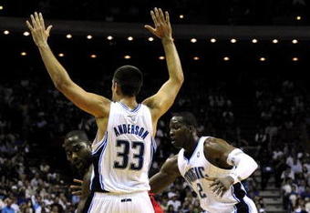 ORLANDO, FL - OCTOBER 28:  Elton Brand #42 of the Philadelphia 76ers looks for an open pass around Ryan Anderson #33 and Mickael Pietrus #20 of the Orlando Magic during the game on October 28, 2009 at Amway Arena in Orlando, Florida.  NOTE TO USER: User expressly acknowledges and agrees that, by downloading and/or using this Photograph, user is consenting to the terms and conditions of the Getty Images License Agreement.  (Photo by Sam Greenwood/Getty Images)