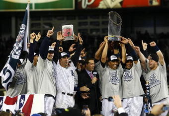 NEW YORK - NOVEMBER 04:  (L-R) A.J. Burnett #34, Jorge Posada #20, Derek Jeter #2, Mariano Rivera #42 (holding trophy) Robinson Cano #24 and Nick Swisher #33 of the New York Yankees against the Philadelphia Phillies in Game Six of the 2009 MLB World Series at Yankee Stadium on November 4, 2009 in the Bronx borough of New York City.  (Photo by Chris McGrath/Getty Images)