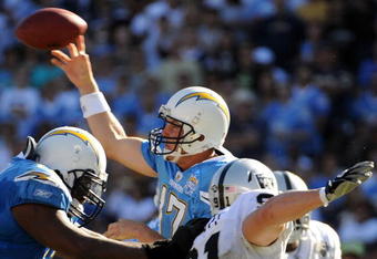 SAN DIEGO - NOVEMBER 01:  Philip Rivers #17 of the San Diego Chargers thorws as he is rushed by Trevor Scott #91 of the Oakland Raiders during the second quarter at Qualcomm Stadium on November 1, 2009 in San Diego California.  (Photo by Harry How/Getty Images)