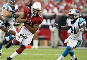 GLENDALE, AZ - NOVEMBER 01:  Wide receiver Larry Fitzgerald #11 of the Arizona Cardinals runs with the ball after a reception during the NFL game against the Carolina Panthers at the Universtity of Phoenix Stadium on November 1, 2009 in Glendale, Arizona. The Panthers defeated the Cardinals 34-21.  (Photo by Christian Petersen/Getty Images)
