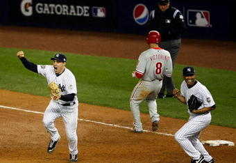 NEW YORK - NOVEMBER 04:  Mark Teixeira #25 (L) and Mariano Rivera #42 (R) of the New York Yankees celebrate after against Shane Victorino #8 (C) of the Philadelphia Phillies grounded out for the final out of the Yankees 7-3 win in Game Six of the 2009 MLB World Series at Yankee Stadium on November 4, 2009 in the Bronx borough of New York City.  (Photo by Chris McGrath/Getty Images)