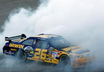 TALLADEGA, AL - NOVEMBER 01:  Jamie McMurray, driver of the #26 IRWIN Marathon Ford, does a burnout after winning the NASCAR Sprint Cup Series AMP Energy 500 at Talladega Superspeedway on November 1, 2009 in Talladega, Alabama.  (Photo by Chris Graythen/Getty Images)