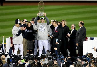 NEW YORK - NOVEMBER 04:  Andy Pettitte #46 of the New York Yankees celebrates with the trophy after their 7-3 win against the Philadelphia Phillies in Game Six of the 2009 MLB World Series at Yankee Stadium on November 4, 2009 in the Bronx borough of New York City.  (Photo by Al Bello/Getty Images)