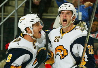 NEWARK, NJ - DECEMBER 13:  Thomas Vanek #26 of the Buffalo Sabres celebrates his third period goal and 10,000 in team history with teammate  Derek Roy #9 against the New Jersey Devils  at the Prudential Center on December 13, 2008 in Newark, New Jersey. Sabres win 4-2  (Photo by Mike Stobe/Getty Images)