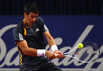 BASEL, SWITZERLAND - NOVEMBER 05:  Novak Djokovic of Serbia plays a backhand in his match against Jan Hernych of Czech Republic during Day Four of the Davidoff Swiss Indoors Tennis at St Jakobshalle on November 5, 2009 in Basel, Switzerland.  (Photo by Julian Finney/Getty Images)