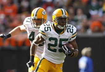 CLEVELAND, OH - OCTOBER 25:  Ryan Grant #25 of the Green Bay Packers runs by Kenyon Coleman #90 of the Cleveland Browns at Cleveland Browns Stadium on October 25, 2009 in Cleveland, Ohio.  (Photo by Matt Sullivan/Getty Images)