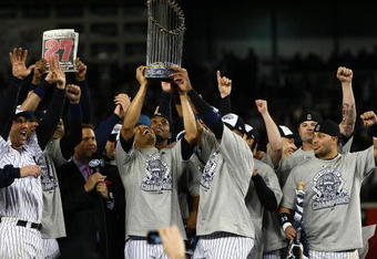 NEW YORK - NOVEMBER 04:  Mariano Rivera #42 of the New York Yankees holds up the trophy as he celebrates with his teammates after their 7-3 win against the Philadelphia Phillies in Game Six of the 2009 MLB World Series at Yankee Stadium on November 4, 2009 in the Bronx borough of New York City.  (Photo by Chris McGrath/Getty Images)