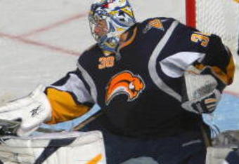 BUFFALO, NY - NOVEMBER 04: Ryan Miller #30 of the Buffalo Sabres makes a save as John Sim #16 of the New York Islanders skates in at HSBC Arena on November4, 2009 in Buffalo, New York.  (Photo by Rick Stewart/Getty Images)