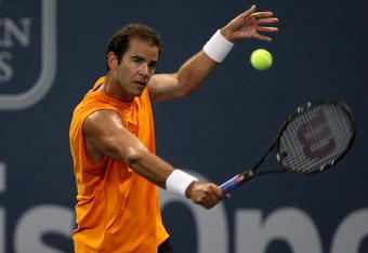 LOS ANGELES, CA - JULY 27:  Tournament honoree Pete Sampras returns a shot to Marat Safin of Russia in the Millennium Challenge during the LA Tennis Open Day 1 at Los Angeles Tennis Center - UCLA on July 27, 2009 in Los Angeles, California.  (Photo by Stephen Dunn/Getty Images)