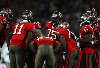 LONDON, ENGLAND - OCTOBER 25: The Tampa Bay Buccaneers offense in discussion during the NFL International Series match between New England Patriots and Tampa Bay Buccaneers at Wembley Stadium on October 25, 2009 in London, England. This is the third occasion where a regular season NFL match has been played in London.  (Photo by Julian Finney/Getty Images)