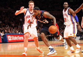 NEW YORK - FEBRUARY 04:  LeBron James #23 of the Cleveland Cavaliers drives to the basket past David Lee #42 of the New York Knicks on February 4, 2009 at Madison Square Garden in New York City. NOTE TO USER: User expressly acknowledges and agrees that, by downloading and or using this photograph, User is consenting to the terms and conditions of the Getty Images License Agreement.  (Photo by Nick Laham/Getty Images)