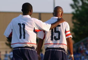 BLAINE, MN - JULY 13:  Forward Freddy Adu #11 of the U.S. Under-17 Men's National Team congradulates his teammate, forward Corey Ashe #15, during the friendly match against Canada Men's Junior Team at the National Sports Center on July 13, 2003 in Blaine, Minnesota.  The U.S. team won 3-1.  (Photo by Eric Miller/Getty Images) 