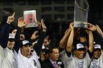 NEW YORK - NOVEMBER 04:  (L-R) A.J. Burnett #34, Jorge Posada #20, Derek Jeter #2, Mariano Rivera #42 (holding trophy) Robinson Cano #24 and Nick Swisher #33 of the New York Yankees against the Philadelphia Phillies in Game Six of the 2009 MLB World Series at Yankee Stadium on November 4, 2009 in the Bronx borough of New York City.  (Photo by Chris McGrath/Getty Images)