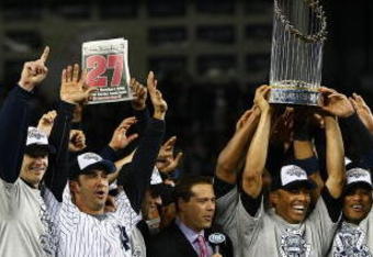NEW YORK - NOVEMBER 04:  (L-R) A.J. Burnett #34, Jorge Posada #20, Derek Jeter #2, Mariano Rivera #42 (holding trophy) Robinson Cano #24 and Nick Swisher #33 of the New York Yankees against the Philadelphia Phillies in Game Six of the 2009 MLB World Series at Yankee Stadium on November 4, 2009 in the Bronx borough of New York City.  (Photo by Chris McGrath/Getty Images)