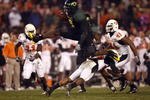 SAN DIEGO, CA - DECEMBER 30:   Runningback LeGarrette Blount #9 of the University of Oregon Ducks hurdles a player en route to a touchdown during his team's 42-31 win over the Oklahoma State University Cowboys in the Pacific Life Holiday Bowl at Qualcomm Stadium on December 30, 2008 in San Diego, California. (Photo by Donald Miralle/Getty Images)