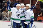 ANAHEIM, CA - OCTOBER 30:  Steve Bernier #18 of the Vancouver Canucks celebrates his goal for a 1-0 lead with Tanner Glass #15 and Aaron Rome #29 against the Anaheim Ducks during the first period at the Honda Center on October 30, 2009 in Anaheim, California.  (Photo by Harry How/Getty Images)