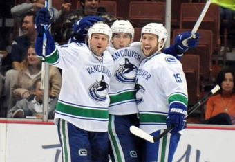 ANAHEIM, CA - OCTOBER 30:  Steve Bernier #18 of the Vancouver Canucks celebrates his goal for a 1-0 lead with Tanner Glass #15 and Aaron Rome #29 against the Anaheim Ducks during the first period at the Honda Center on October 30, 2009 in Anaheim, California.  (Photo by Harry How/Getty Images)