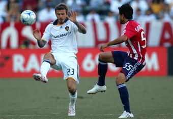 CARSON, CA - NOVEMBER 01:  David Beckham #23 of the Los Angeles Galaxy pressures the play of Marcelo Saragosa #55 of Chivas USA in the first half during Game 1 of the MLS Western Conference Semifinals match at The Home Depot Center on November 1, 2009 in Carson, California.  The Galaxy and Chivas USA played to a 2-2 draw. (Photo by Victor Decolongon/Getty Images)