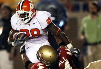 TALLAHASSEE, FL - SEPTEMBER 16:  Linebacker Marcus Ball #44 of the Florida State Seminoles brings down running back C.J. Spiller #28 of the Clemson Tigers at Doak Campbell Stadium on September 16, 2006 in Tallahassee, Florida.  (Photo by Doug Benc/Getty Images)