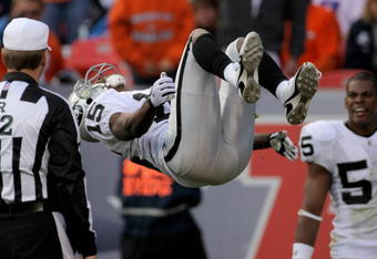 DENVER - NOVEMBER 23:  Johnnie Lee Higgins #15 of the Oakland Raiders celebrates with a back flip in front of referee Jeff Triplette after his 89 yard punt return for a second quarter touchdown against the Denver Broncos during week 12 NFL action at Invesco Field at Mile High on November 23, 2008 in Denver, Colorado. The beckflip earned a 15 yard penalty as the Raiders defeated the Broncos 31-10.  (Photo by Doug Pensinger/Getty Images)