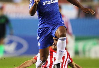 MADRID, SPAIN - NOVEMBER 03:  Didier Drogba   of Chelsea skips the tackle from Pablo Ibanez of Atletico Madrid during Champions League Group D match between Atletico Madrid and Chelsea at the Vicente Calderon Stadium on November 3, 2009 in Madrid, Spain.  (Photo by Shaun Botterill/Getty Images)