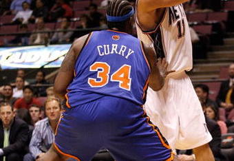 EAST RUTHERFORD, NJ - OCTOBER 20:  Eddie Curry #34 of the New York Knicks defends Brook Lopez #11 of the New Jersey Nets during the second half of a pre-season game on October 20, 2008 at the IZOD Center in East Rutherford, New Jersey. The Knicks won 114-106.  NOTE TO USER: User expressly acknowledges and agrees that, by downloading and/or using this Photograph, user is consenting to the terms and conditions of the Getty Images License Agreement.  (Photo by Jarrett Baker/Getty Images)