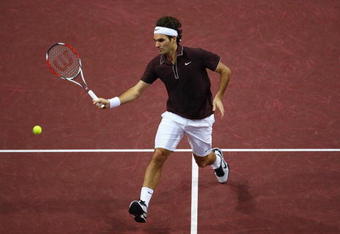 BASEL, SWITZERLAND - NOVEMBER 07:  Roger Federer of Switzerland plays a volley in his match against Marco Chiudinelli of Switzerland during Day Six of the Davidoff Swiss Indoors Tennis at St Jakobshalle on November 7, 2009 in Basel, Switzerland.  (Photo by Julian Finney/Getty Images)