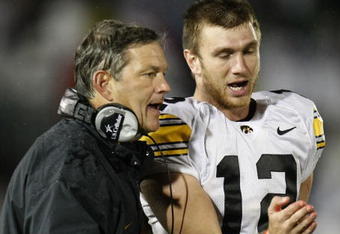 STATE COLLEGE, PA - SEPTEMBER 26:  Head coach Kirk Ferentz of the Iowa Hawkeyes talks with Ricky Stanzi #12 while playing the Penn State Nittnay Lions  on September 26, 2009 at Beaver Stadium in State College, Pennsylvania. Iowa won the game 21-10. (Photo by Gregory Shamus/Getty Images)