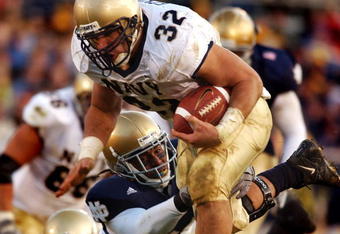 SOUTH BEND, IN - NOVEMBER 8:  In this U.S. Navy handout photo, Navy fullback Kyle Eckel evades a Notre Dame defender to gain yardage during the Navy's Midshipmen's 27-24 loss to the Fighting Irish November 8, 2003 in South Bend, Indiana.  (Photo by Scott Allen/U.S. Navy via Getty Images)