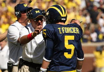 ANN ARBOR, MI - SEPTEMBER 19:  Head coach Rich Rodriguez of the Michigan Wolverines talks with quarterback Tate Forcier #5 during the game with the Eastern Michigan Eagles at Michigan Stadium on September 19, 2009 in Ann Arbor, Michigan.  Michigan won 45-17.  (Photo by Stephen Dunn/Getty Images)