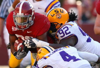 TUSCALOOSA, AL - NOVEMBER 07:  Mark Ingram #22 of the Alabama Crimson Tide is tackled by Drake Nevis #92 and Jai Eugene #4 of the Louisiana State University Tigers at Bryant-Denny Stadium on November 7, 2009 in Tuscaloosa, Alabama.  (Photo by Kevin C. Cox/Getty Images)