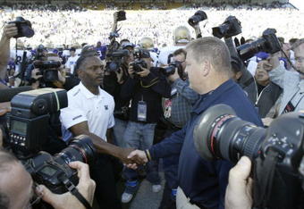 SEATTLE - SEPTEMBER 24:  Head Coach Tyrone Willingham of the Washington Huskies (L) shakes hands after the game with Head Coach Charlie Weis of the Notre Dame Fighting Irish on September 24, 2005 at Husky Stadium in Seattle, Washington. The Irish defeated the Huskies 36-17. (Photo by Otto Greule Jr/Getty Images) 
