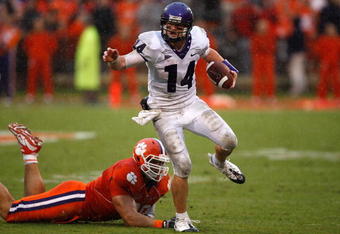 CLEMSON, SC - SEPTEMBER 26:  Andy Dalton #14 of the TCU Horned Frogs runs with the ball as Miguel Chavis #89 of the Clemson Tigers tries to tackle him during their game at Memorial Stadium on September 26, 2009 in Clemson, South Carolina.  (Photo by Streeter Lecka/Getty Images)
