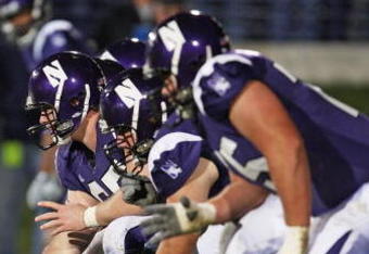 EVANSTON, IL - OCTOBER 31: Ben Burkett #65 of the Northwestern Wildcats prepares to snap the ball against the Penn State Nittany Lions at Ryan Field on October 31, 2009 in Evanston, Illinois. Penn State defeated Northwestern 34-13. (Photo by Jonathan Daniel/Getty Images)