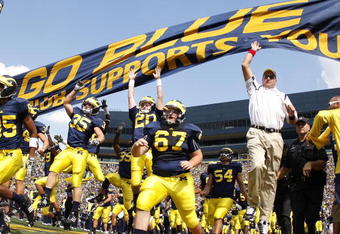 ANN ARBOR, MI - SEPTEMBER 05:  Head coach Rich Rodriguez enters the stadium with his team prior to playing the Western Michigan Broncos on September 5, 2009 at Michigan Stadium in Ann Arbor, Michigan.  (Photo by Gregory Shamus/Getty Images)
