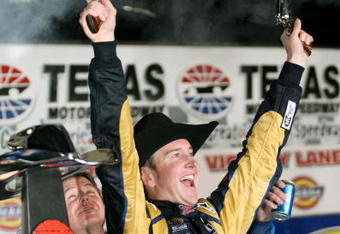 FORT WORTH, TX - NOVEMBER 08:  Kurt Busch, driver of the #2 Miller Lite Dodge, celebrates by firing two Beretta's into the air on victory lane after winning the NASCAR Sprint Cup Series Dickies 500 at Texas Motor Speedway on November 8, 2009 in Fort Worth, Texas.  (Photo by Tom Pennington/Getty Images for NASCAR)