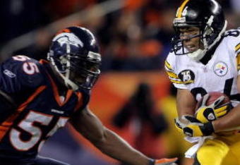 DENVER - OCTOBER 21:  Hines Ward #86 of the Pittsburgh Steelers makes a reception as D.J. Williams #55 of the Denver Broncos defends at Invesco Field at Mile High on October 21, 2007 in Denver, Colorado. The Broncos defeated the Steelers 31-28.  (Photo by Doug Pensinger/Getty Images)