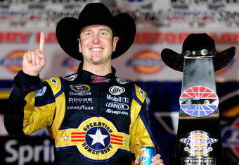 FORT WORTH, TX - NOVEMBER 08:  Kurt Busch, driver of the #2 Miller Lite Dodge, poses with the trophy on victory lane after winning the NASCAR Sprint Cup Series Dickies 500 at Texas Motor Speedway on November 8, 2009 in Fort Worth, Texas.  (Photo by Rusty Jarrett/Getty Images for NASCAR)