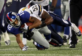 EAST RUTHERFORD, NJ - NOVEMBER 08:  Steve Smith #12 of the New York Giants is tackled Brandon Siler #59 of the San Diego Chargers at Giants Stadium on November 8, 2009 in East Rutherford, New Jersey.  (Photo by Nick Laham/Getty Images)