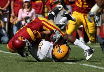 LOS ANGELES, CA - OCTOBER 11: Linebacker Mike Nixon #25 of the Arizona State Sun Devils is tackled by wide receiver Ronald Johnson #8  after maiking an interception on October 10, 2008 at the Los Angeles Coliseum in Los Angeles, California.  usc WON 28-0.  (Photo by Stephen Dunn/Getty Images)