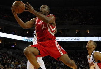 OAKLAND, CA - DECEMBER 12:  Carl Landry #14 of the Houston Rockets lays the ball up past Anthony Randolph #4 of the Golden State Warriors during the game on December 12, 2008 at Oracle Arena in Oakland, California.  The Rockets won 119-108.  NOTE TO USER: User expressly acknowledges and agrees that, by downloading and or using this photograph, User is consenting to the terms and conditions of the Getty Images License Agreement.  (Photo by Jed Jacobsohn/Getty Images)