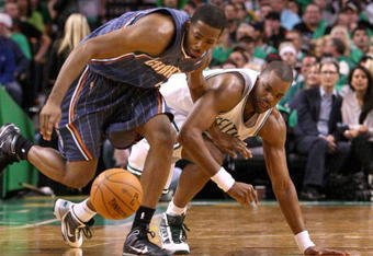 BOSTON, MA - OCTOBER 28:  Derrick Brown #4 of the Charlotte Bobcats fights for a loose ball with Shelden Williams #13 of the  Boston Celtics at the TD Banknorth Garden on October 28, 2009 in Boston, Massachusetts. NOTE TO USER: User expressly acknowledges and agrees that, by downloading and/or using this Photograph, user is consenting to the terms and conditions of the Getty Images License Agreement. (Photo by Jim Rogash/Getty Images)