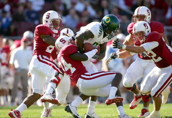 PALO ALTO, CA - NOVEMBER 07:  Kris Evans #24 of the Stanford Cardinal tackles Ed Dickson #83 of the Oregon Ducks at Stanford Stadium on November 7, 2009 in Palo Alto, California.  (Photo by Ezra Shaw/Getty Images)