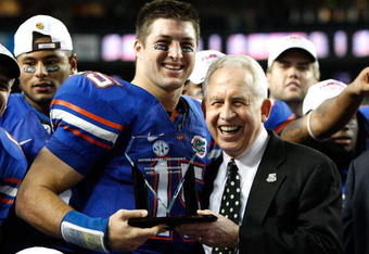 ATLANTA - DECEMBER 06:  Quarterback Tim Tebow #15 of the Florida Gators receives the Most Valuable Player award from SEC Commissioner Mike Slive after the Gators 31-20 win over the Alabama Crimson Tide in the SEC Championship on December 6, 2008 at the Georgia Dome in Atlanta, Georgia.  (Photo by Kevin C. Cox/Getty Images)
