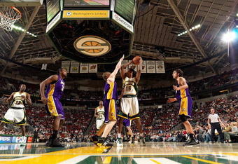 SEATTLE - FEBRUARY 24:  Mickael Gelabale #15 of the Seattle SuperSonics looks to pass over Coby Karl #11 of the Los Angeles Lakers during the game on February 24, 2008 at Key Arena in Seattle, Washington.  The Lakers won 111-91.  NOTE TO USER: User expressly acknowledges and agrees that, by downloading and/or using this Photograph, user is consenting to the terms and conditions of the Getty Images License Agreement. (Photo by Otto Greule Jr/Getty Images)