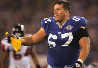 EAST RUTHERFORD, NJ - NOVEMBER 21:  Guard Chris Snee #67 of the New York Giants looses his helmet and catches the flag on a penalty against the Atlanta Falcons in the third quarter at Giants Stadium on November 21, 2004 in East Rutherford, New Jersey. The Falcons defeated the Giants 14-10.  (Photo by Harry How/Getty Images)