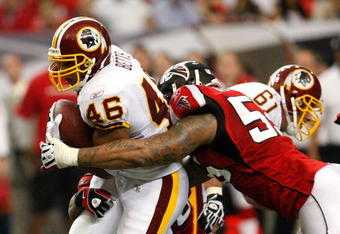 ATLANTA - NOVEMBER 08:  John Abraham #55 of the Atlanta Falcons tackles Ladell Betts #46 of the Washington Redskins at Georgia Dome on November 8, 2009 in Atlanta, Georgia.  (Photo by Kevin C. Cox/Getty Images)
